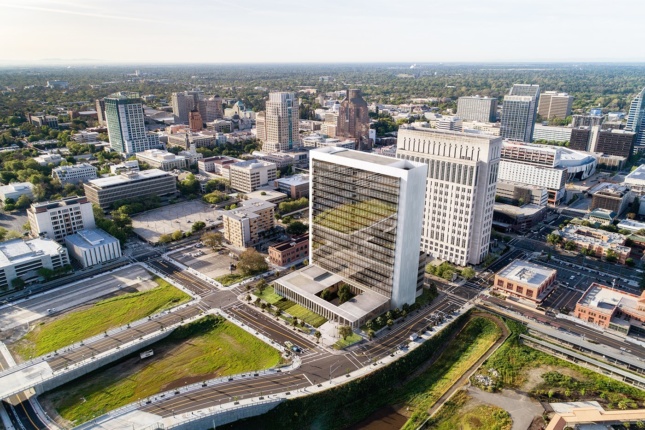 Aerial rendering of glass-facade courthouse with street and landscape surrounding 