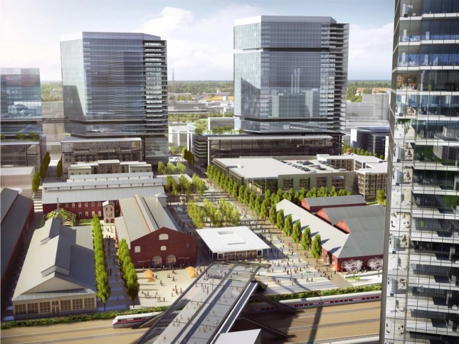 Aerial rendering of mixed-use development with red brick structures surrounded by new glass towers 