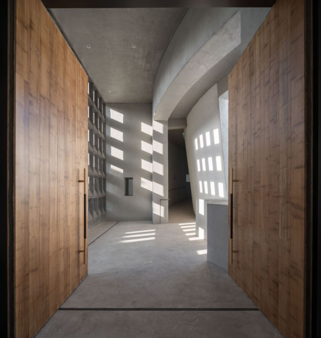 Wooden wall paneling lining a concrete corridor