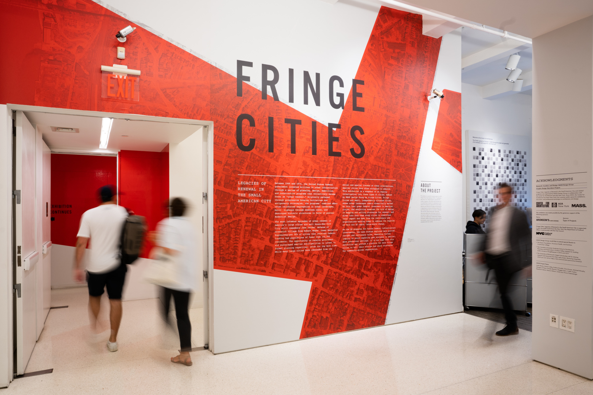 A white wall with the words FRINGE CITIES in red text