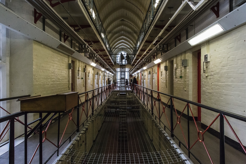 A perspective photo looking down the hallway of a prison where Oscar Wilde was once held