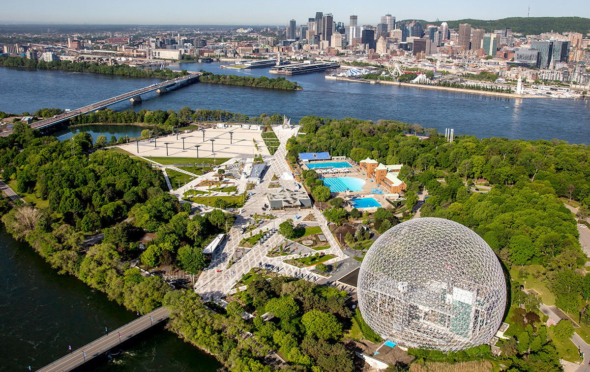 An aerial photograph shows Montreal's Parc Jean-Drapeau with it's large geodesic dome and green landscape.