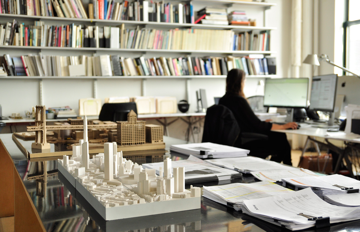 Image of architecture office with models, books, and paperwork at the Alloy office