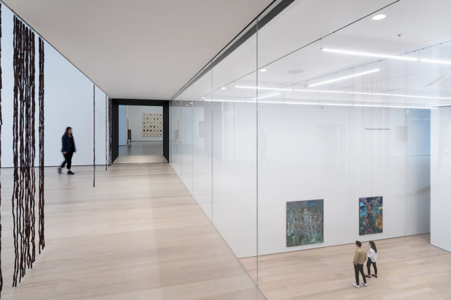 Image of glass wall separating two floors of gallery space
