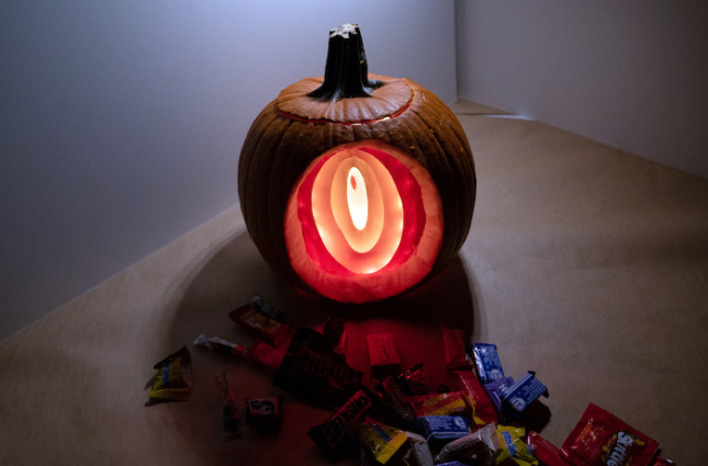 A tunnel carved into an illuminated pumpkin