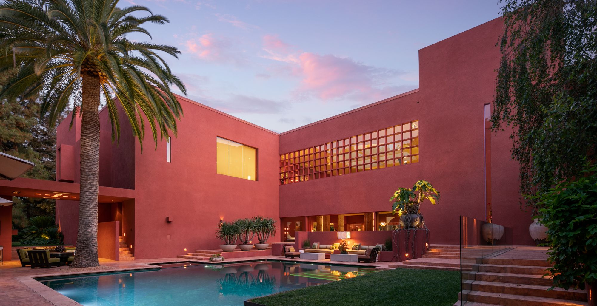 Photo of a pool surrounded by red walls in a Ricardo Legorreta home