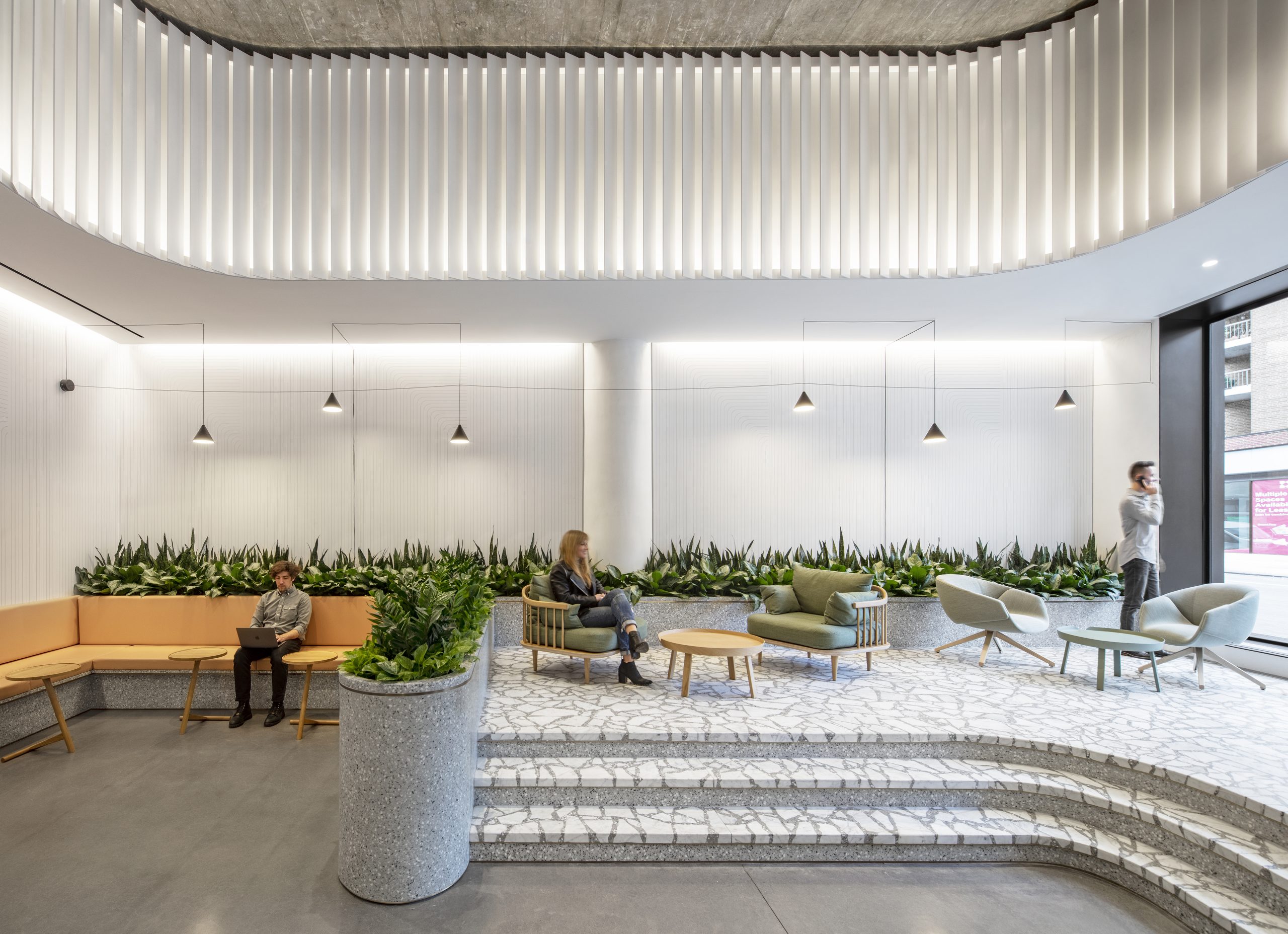 A large lobby decked out in granite and concrete in Manhattan's Hudson Square