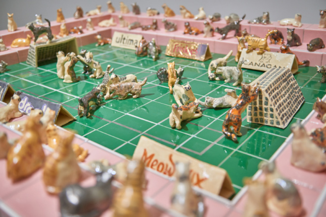 A model stadium with cats playing soccer
