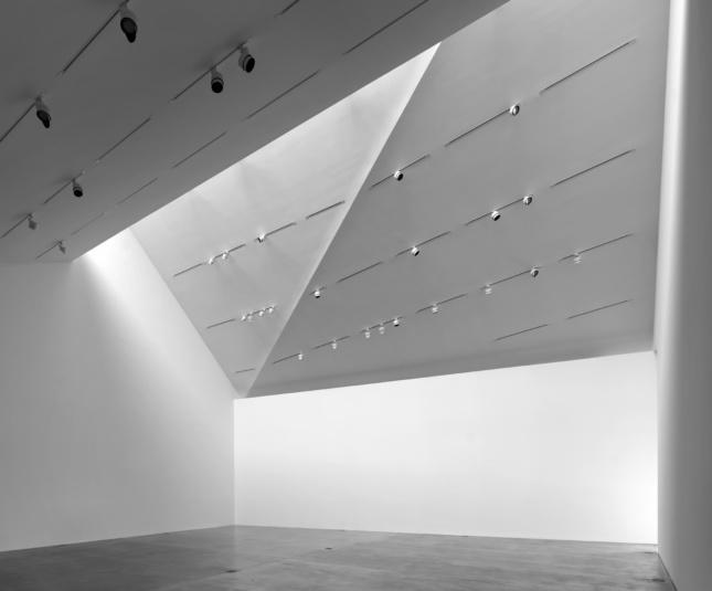 Interior of a white triangular gallery space with no art