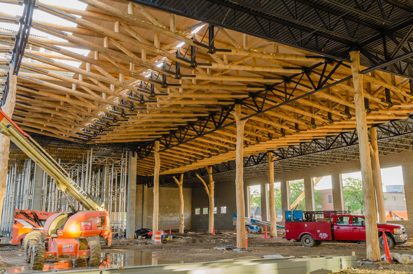Very tall timber trusses being installed in a WholeTrees grocery store