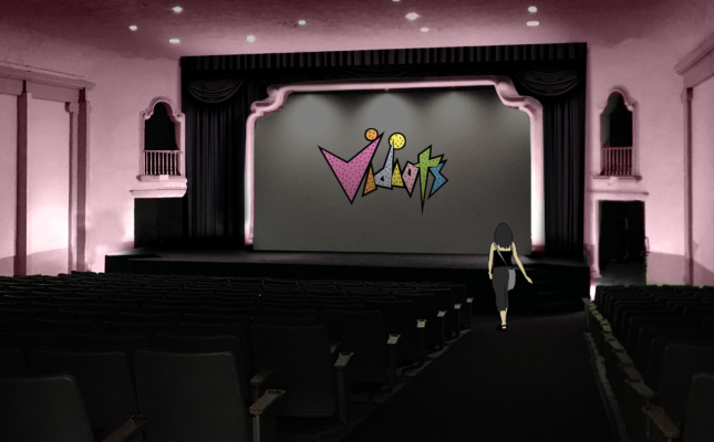 A video screen in a pink theater with VIDIOTS on it