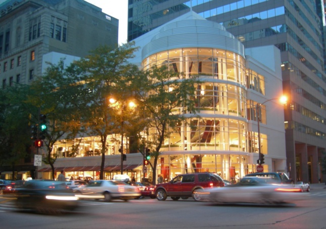 Exterior photo of a spiraling Crate and Barrel store clad in glass
