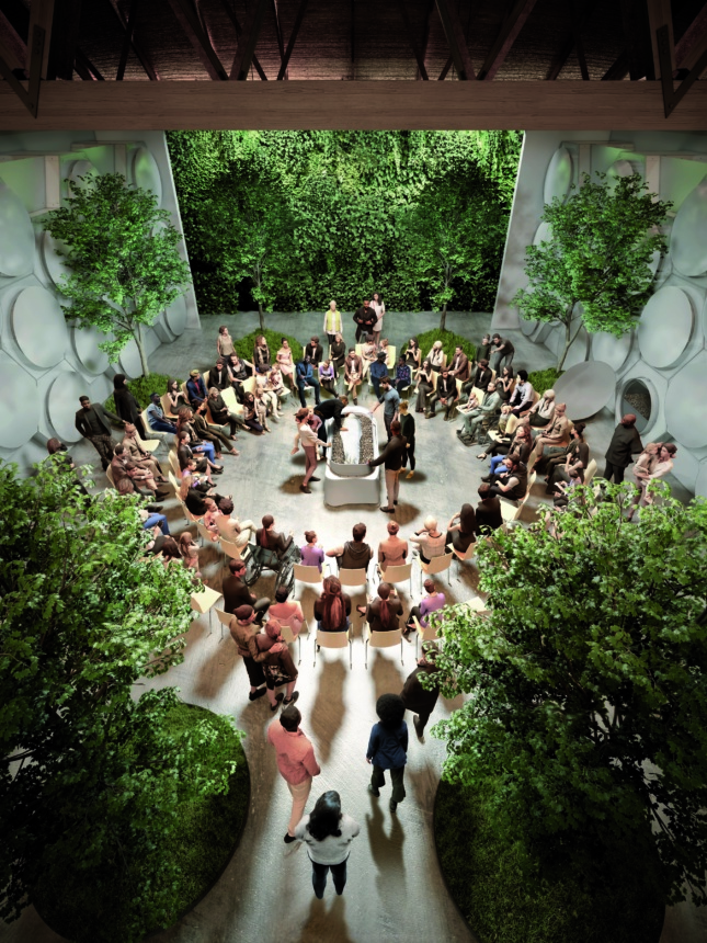 A large group of people gather around in a circle for an after-death ceremoniy in a central room surrounded by green trees and a living wall. 