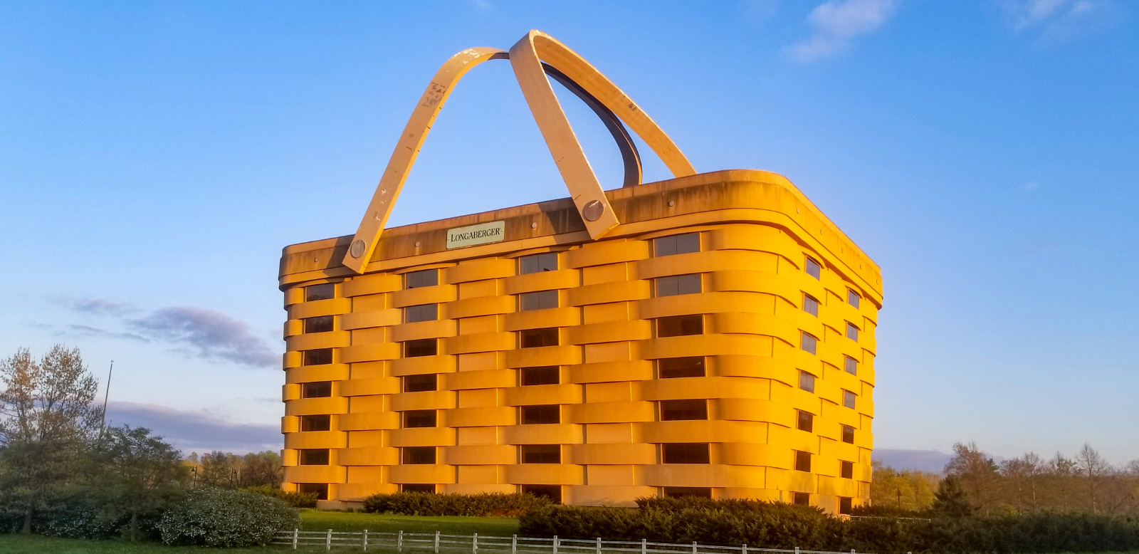 Roadside photo of a massive basket-shaped building