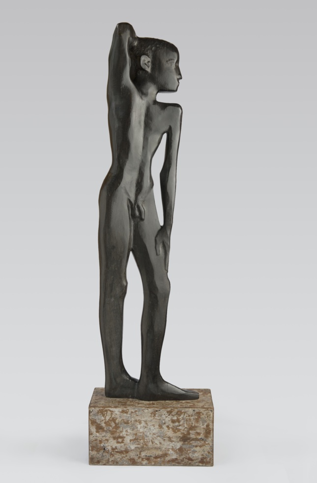 A sculpture of a young black boy standing with his arm draped over his head