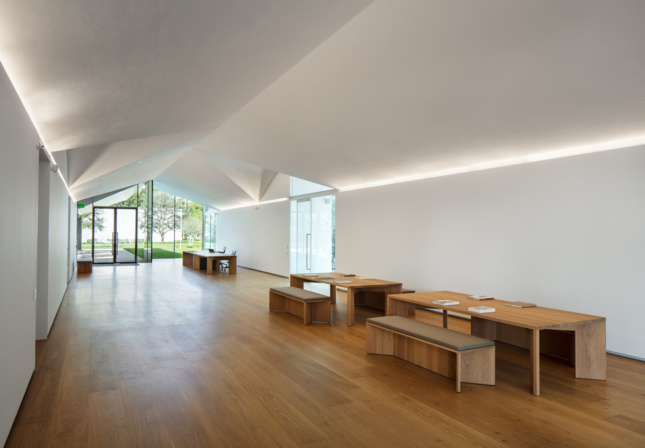 A timber floored hall with benches