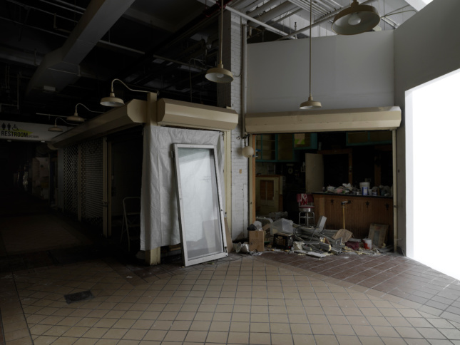 Interior photo of a darkened construction site at Essex Street Market