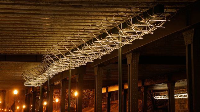 an outdoor lighting installation underneath an elevated platform