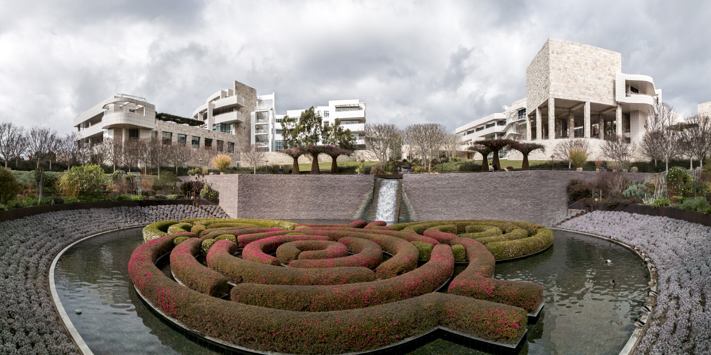 A wide panoramic shot of several imposing white buildings that comprise the Getty Center