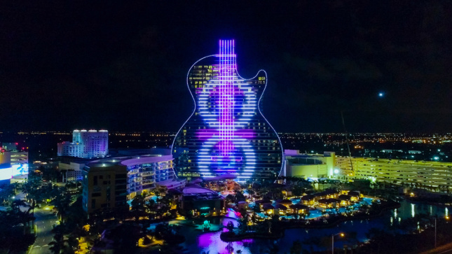 Aerial image of guitar-shaped building with purple and blue lights