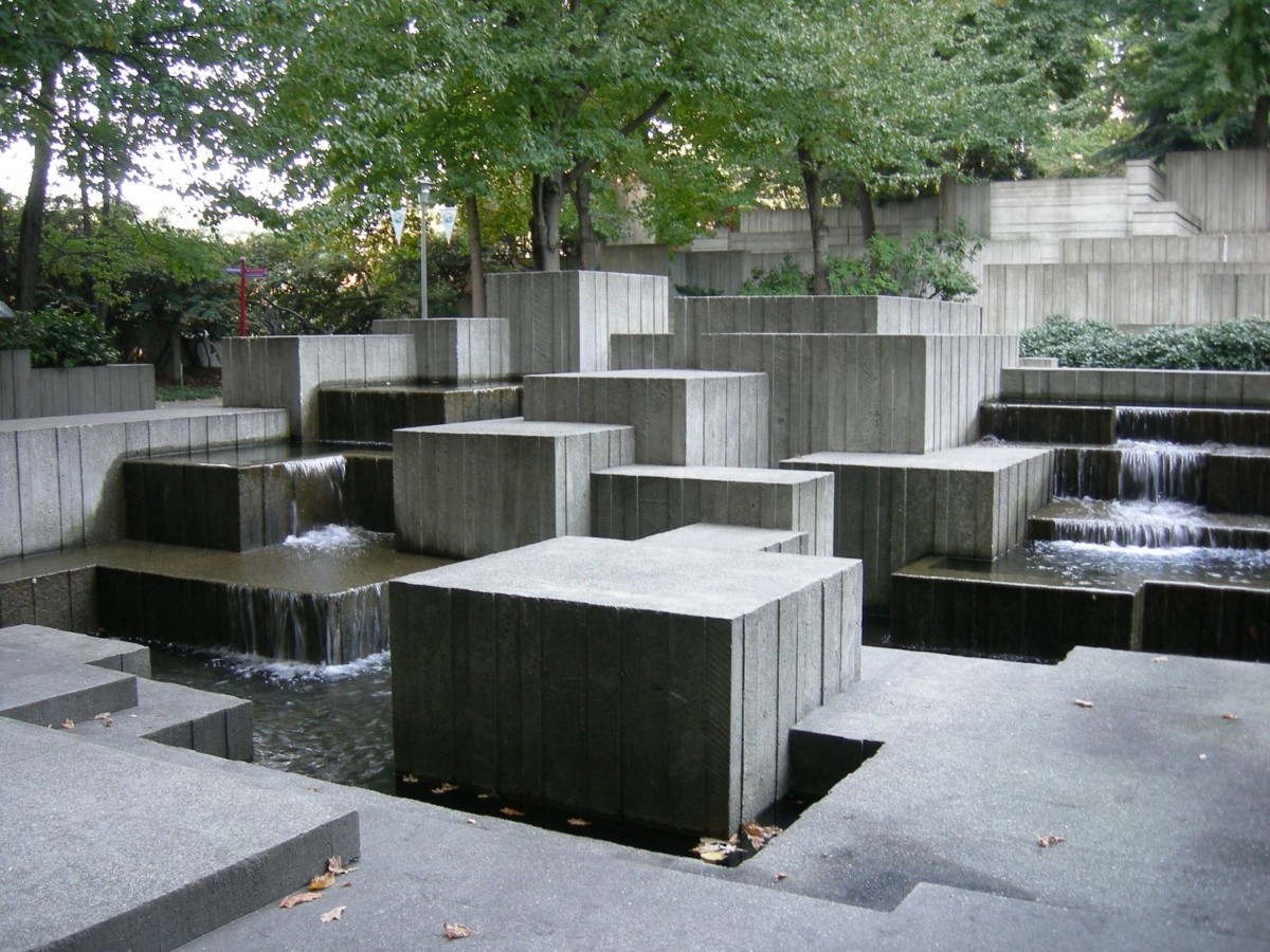 Image of park with concrete blocks on top of a water feature and pond