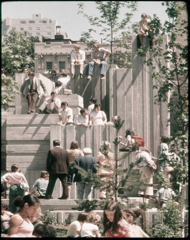 Old photo of people sitting on concrete blocks in park
