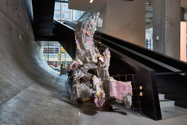Large-scale mixed media sculpture in situ next to a staircase