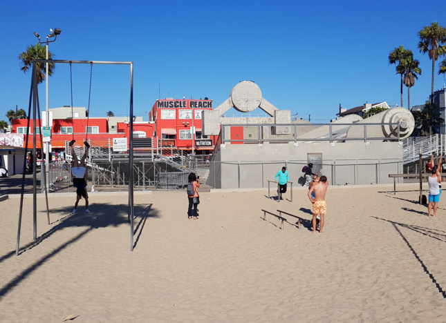 People working out at a beachside gym on Muscle Beach