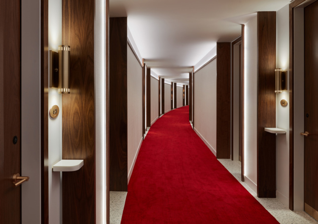 The interior lighting of a TWA Hotel corridor