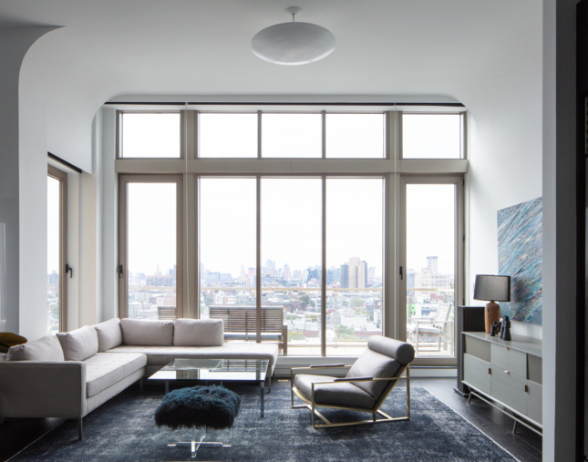 apartment interior with floor-ceiling window overlooking city