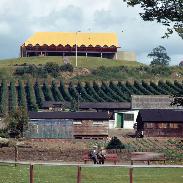A yellow-topped building on a hill