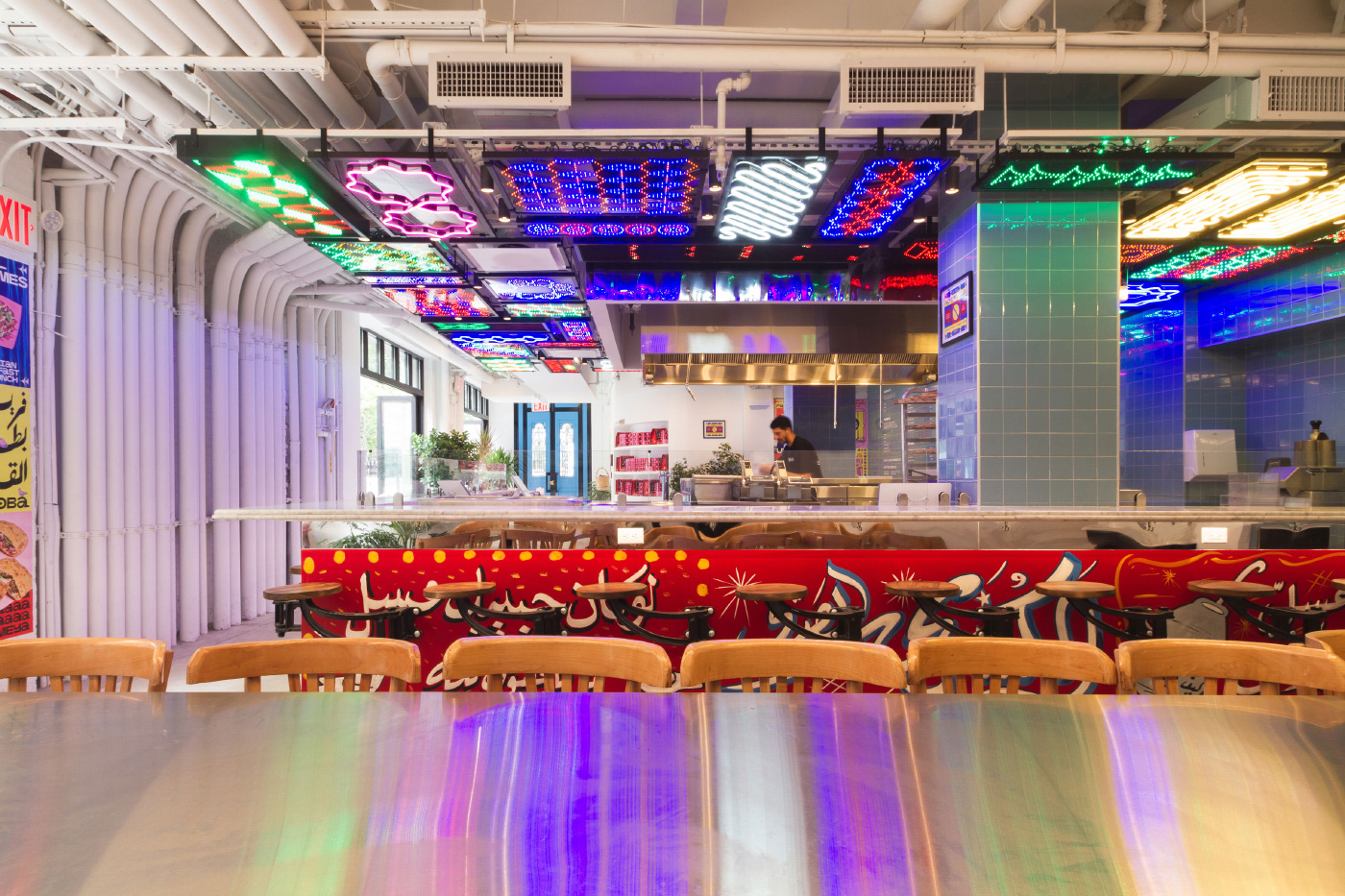 The interior of a Zooba restaurant, adorned in neon lights
