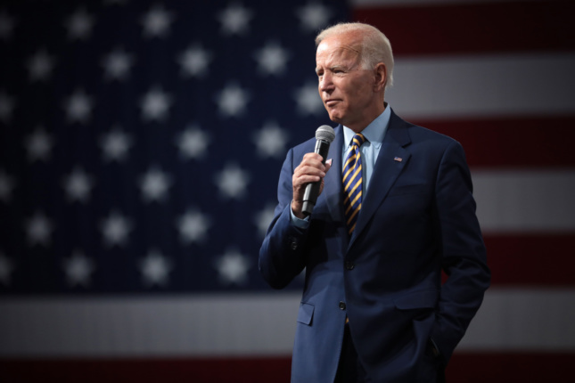 Portrait of Joe Biden in front of a flag