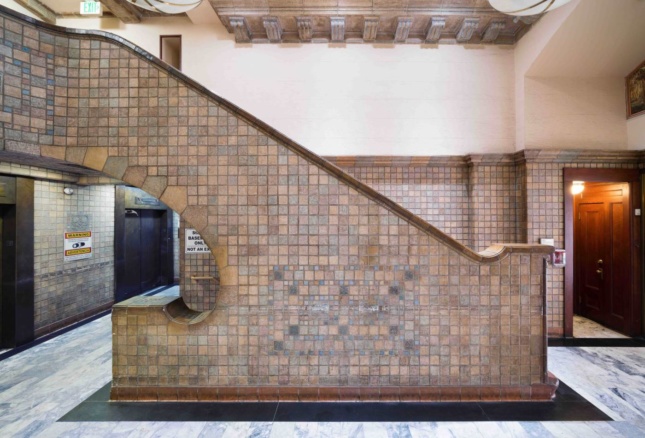 Interior photo of a staircase landing with tile-clad lobby