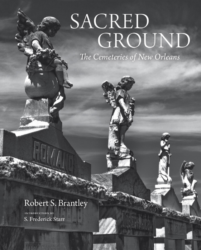 Cover of a black-and-white book with the words Sacred Ground on the front