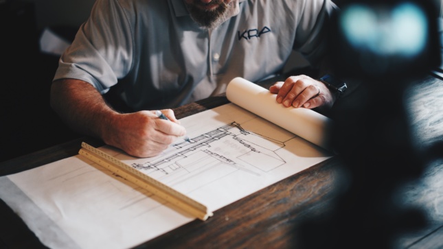 Image of architect drawing at desk