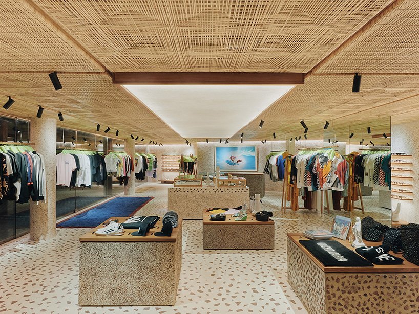 Interior of a retail store with rattan panels and terrazzo flooring