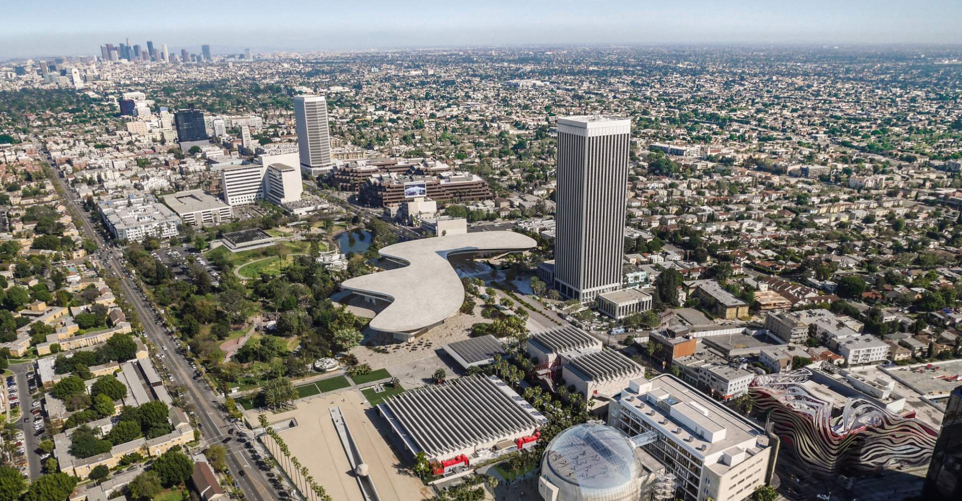 Aerial rendering of a large, flat, blobby-shaped building spanning an entire block, the new LACMA