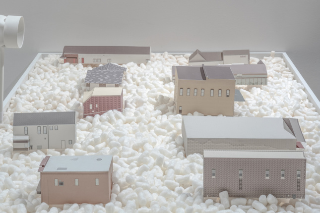 Different housing types sit among packing peanuts
