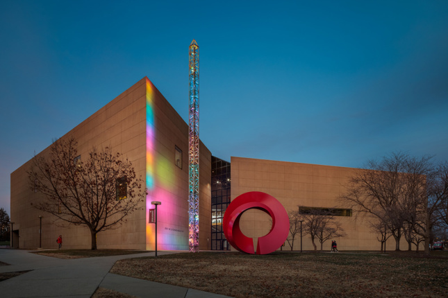 Night exterior shot of museum with colorful side lighting
