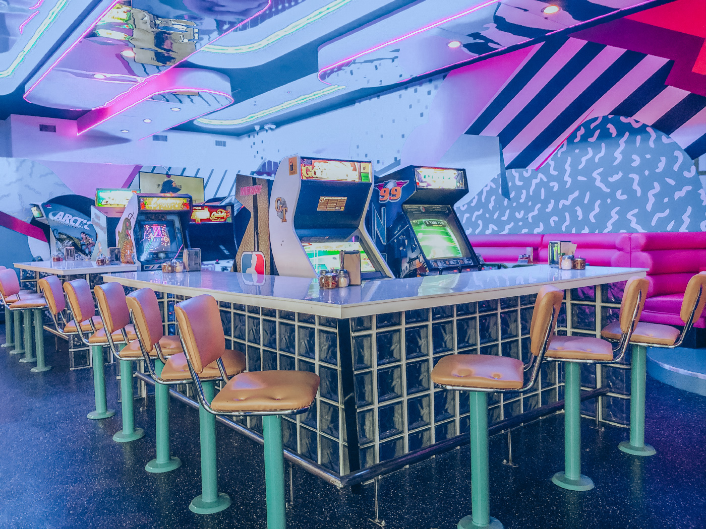 A neon-drenched pizza parlor
