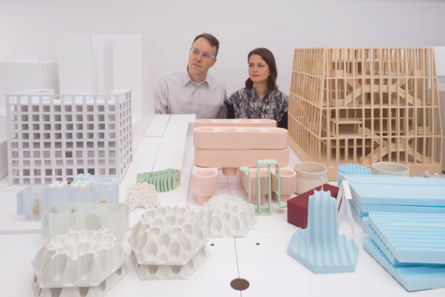 Two people above architectural models