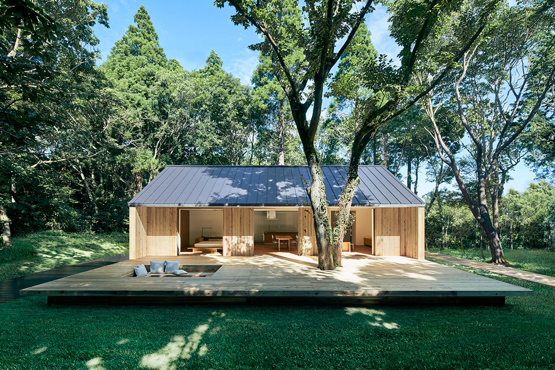 Exterior photo of a short, gabled house designed by Muji