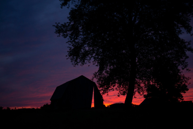 Silhouette of Secret Sky, a barn with a sliver cut out of it