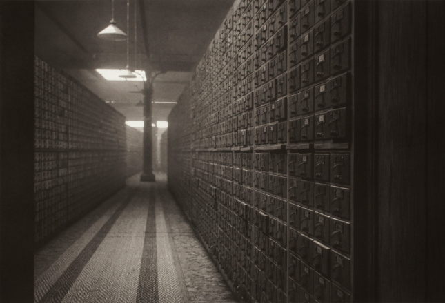 Sepia photo fo filing cabinets around a track on display at Peter Freeman