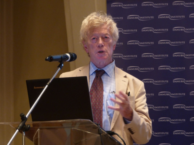 Roger Scruton, an older man with floppy hair, at a lectern