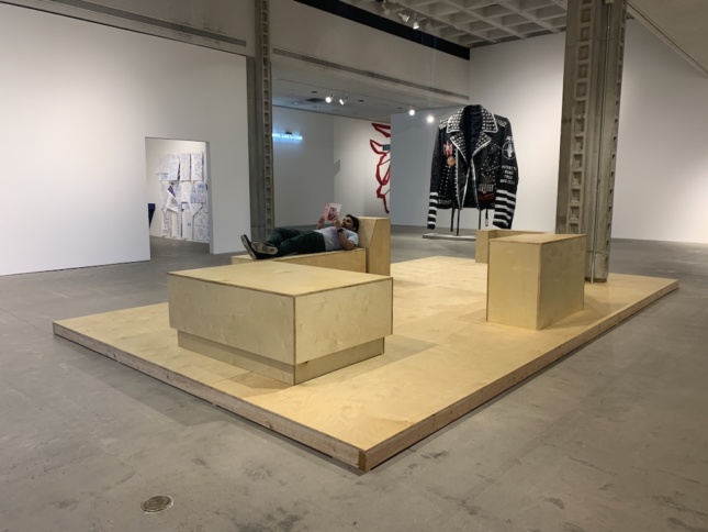 Interior of a gallery with plywood boxes in the center