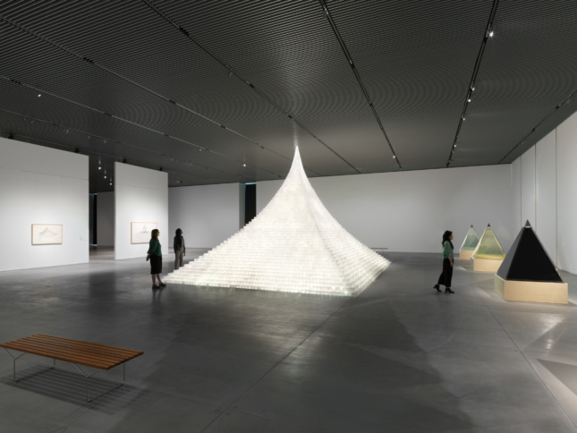 A tall, glowing pyramid designed by Agnes Denes