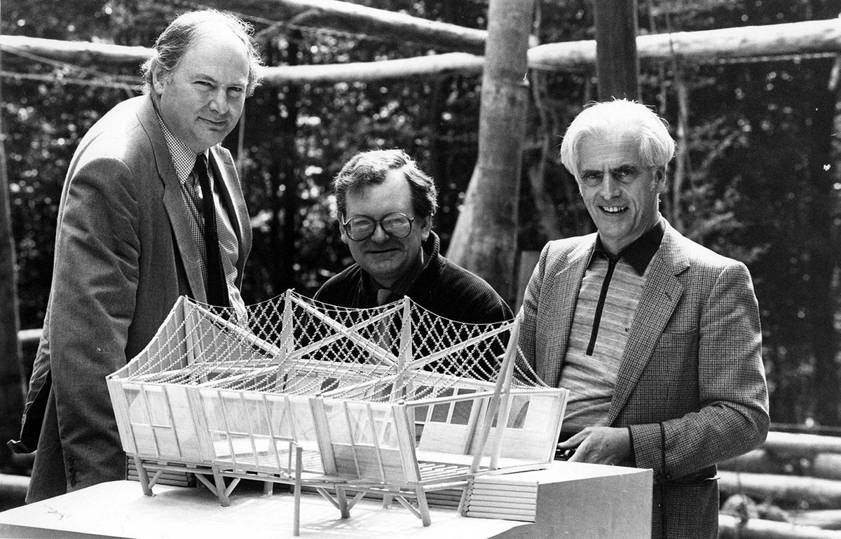 Richard Burton, John Makepeace, and Frei Otto posing with timber structure model