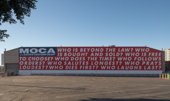 Building with words on wall that reads "MOCA the Geffen Contemporary", from artist Barbara Kruger